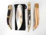 several different types of knives are lined up on a white surface