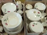 a lot of dishes and cups in a box