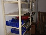 a shelf with baskets and containers on it in a room