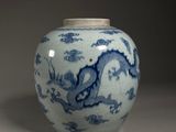 a blue and white vase sitting on a table