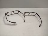 a pair of glasses sitting on a white surface