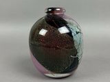 a small vase with a black and purple design on it