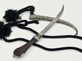 two different types of knives on a white surface