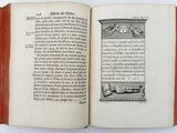an open book with a picture of a man laying on a bed
