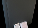 a black binder with two bags of tissues next to it