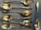 five spoons that are sitting on a table