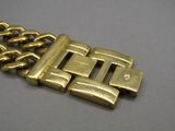 an image of a close up of a gold bracelet on a table