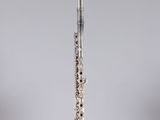 the flute is in a clear glass holder on the table