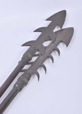 two old metal tools that are on a white surface