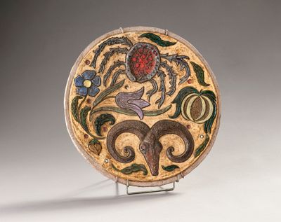 a plate with a design on it sitting on a stand