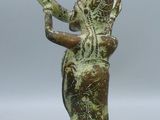 an old bronze figurine of a man with a pipe in his hand