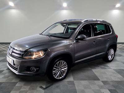 the volkswagen tiguan is parked on a checkered tile floor