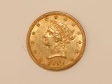 a close up of a gold coin on a white surface