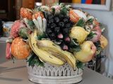 un panier blanc rempli de fruits et de légumes posé sur un comptoir