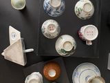many different types of vases and bowls on the table