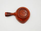 an old wooden pipe with a brown handle on a white surface