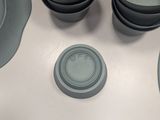 a lot of plates and bowls on the table