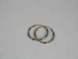 two silver and gold hoop earrings on a white surface