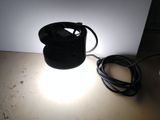 a light that is sitting on a table next to a lamp