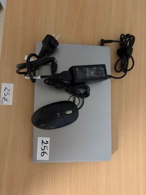 a laptop and a mouse on a table with a price tag