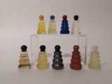 a lot of different colored glass chess pieces on the table