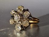 a gold ring with a bunch of diamonds on it