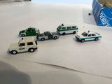 four toy cars that are sitting on a table