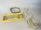a computer keyboard and a charger on a table