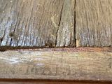 a close up of a wooden table with peeling wood