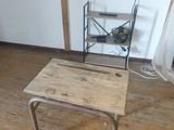 a small table with a book shelf in the corner of the room