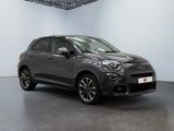 a grey fiat suv parked in a large room