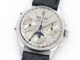 a close up of a watch on a white surface with a black strap