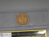 a gold coin sitting on top of a plastic case