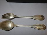 two spoons and a fork sitting on a table