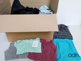 a cardboard box filled with clothes and a tag