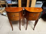 pair of wooden nightstand tables with drawers on each side of them