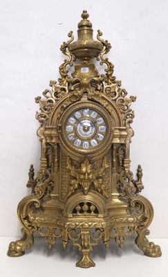 a gold clock sitting on top of a white table
