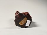 a small figurine of a bear with a tag on it