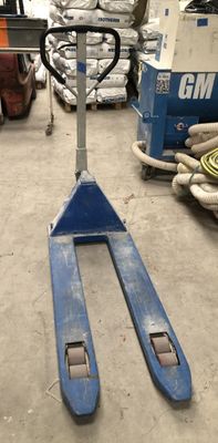 a fork lifter that is sitting in a warehouse