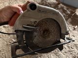 a person holding a circular saw in their hand