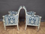 pair of blue and white painted chairs and a mirror on a wooden floor