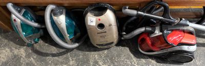 several vacuums are lined up next to each other on the floor