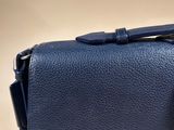 navy blue leather handbag with a metal clasp on a white background