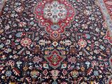 a close up of a large oriental rug on a wooden floor