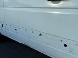 a white van with holes in the side of it