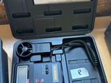 a black case with a digital meter in it on a table