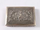 an antique silver box with a picture of a man on a horse on it