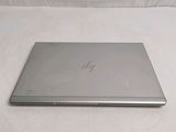 a laptop that is sitting on a white surface