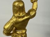 brass statue of a man holding a bird on a tray