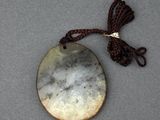 an image of a necklace with a stone pendant on a cord